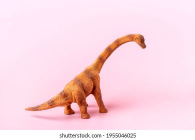 Toy Dinosaur Diplodocus Isolated On Pink Background Holiday Card  Creative Minimal Concept