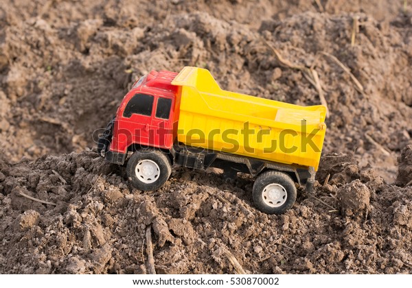 toy dump truck on the\
ground.