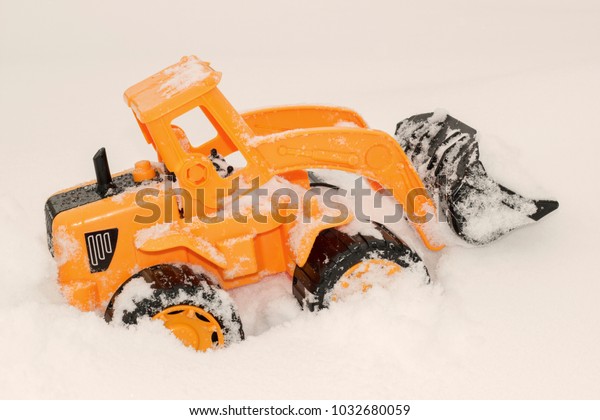 toy excavator in the\
snow