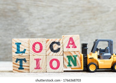 Toy Forklift Hold Letter Block A N To Complete Word Location On Wood Background