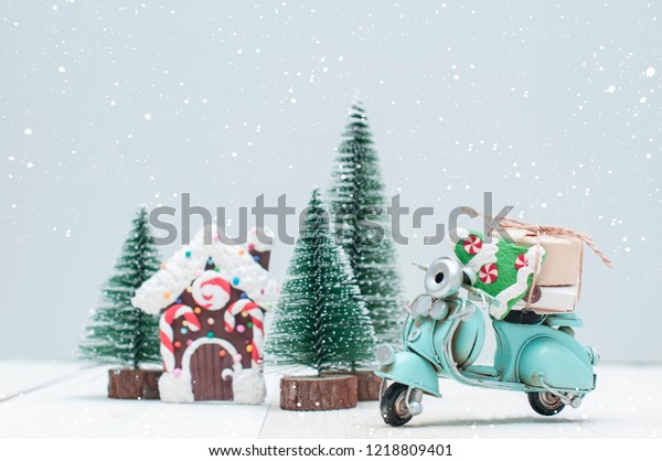 Toy gingerbread house where\
magic elves live in christmas trees town and motorbike with\
gifts