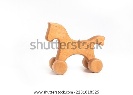 Toy - handmade wooden horse on wheels isolated on white background
