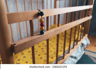 The Toy Hangs On An Empty Crib.