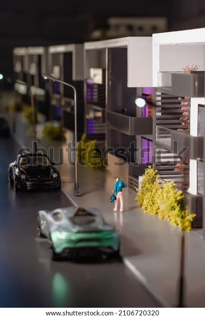 Toy house and\
cars, miniature residential\
area.