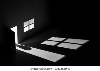 Toy House With Light Falling Through Door And Window To Make A Creepy Shadow