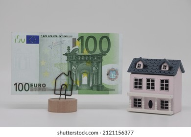 The Toy House Stands Next To The Banknote On The Stand. Accurate Financial Calculation When Buying A Property