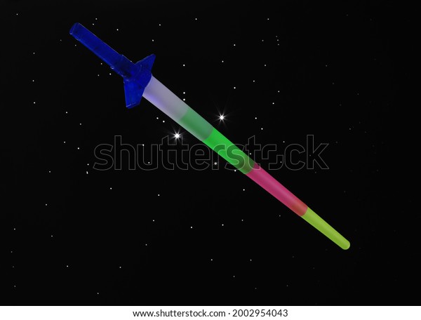 toy laser sword on black\
background