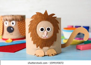 Toy Lion Made Of Toilet Paper Roll On Blue Wooden Table