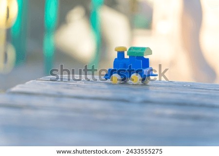 A toy locomotive left behind in the park
