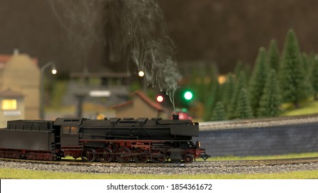 Toy Locomotive With Steam. Side View Train Model.