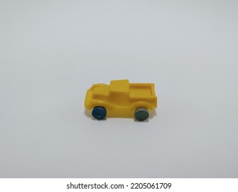 Toy Mini Car, Yellow Color Vehicle On White Background.