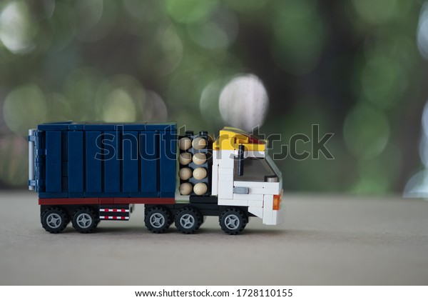 Toy miniature truck on a wooden table.\
using as transportation and logistic\
concept