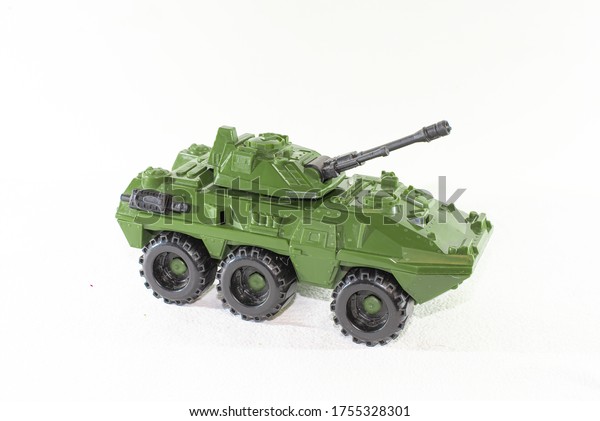 A toy model of an armored car is turned\
sideways on a white\
background