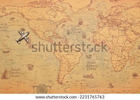 Toy model plane, classic vintage small passenger airplane on the vintage style map background. Arriving USA west coast from pacific ocean