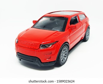 Toy Model Of A Red Color SUV Car On A White Background