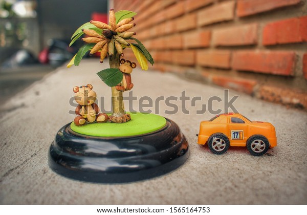Toy monkeys and\
miniature toy cars. 