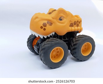 toy monster truck, The image shows a yellow toy monster truck with a dinosaur head. The truck has large, on white background 