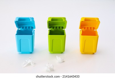 Toy multi-colored containers for sorting garbage on a white background - Shutterstock ID 2141643433