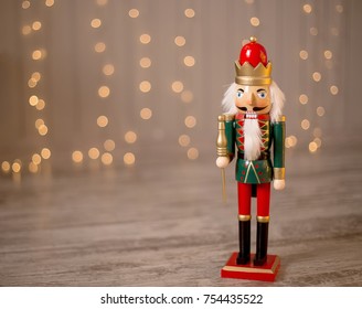 Toy Nutcracker On A Festive Background