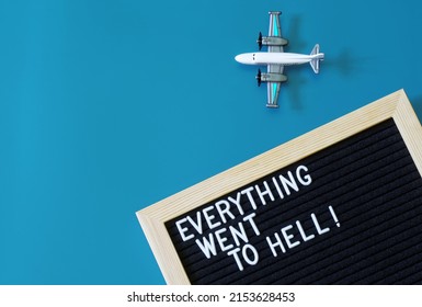 Toy Passenger Plane Next To A Felt Board That Says Everything Went To Hell. The Concept Of Depression, Fatigue, Disappointment And Relocation, Or Going On Vacation. Blue Background. Close-up