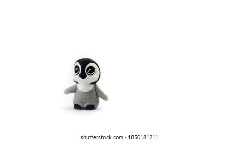 Toy penguin model isolated on white background. Small cute toy close-up.