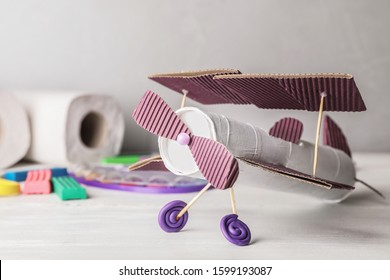 Toy Plane Made Of Toilet Paper Hub On White Wooden Table