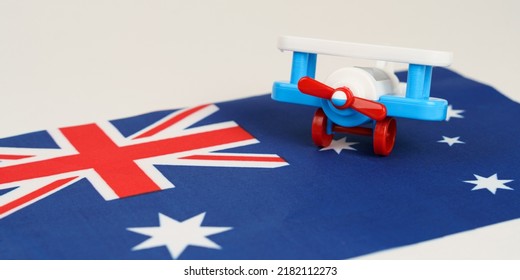 A Toy Plane Stands On The Flag - Australia. Travel And Business Concept