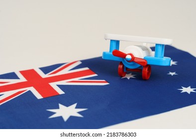 A Toy Plane Stands On The Flag - Australia. Travel And Business Concept