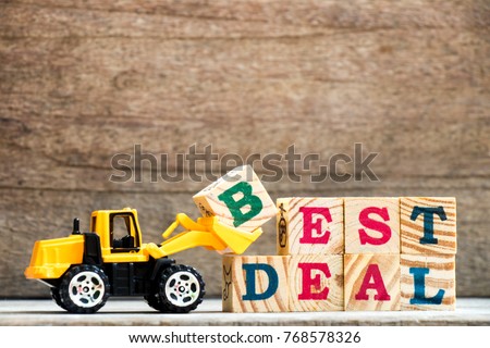 Toy plastic bulldozer hold letter block H to complete wording best deal on wood background