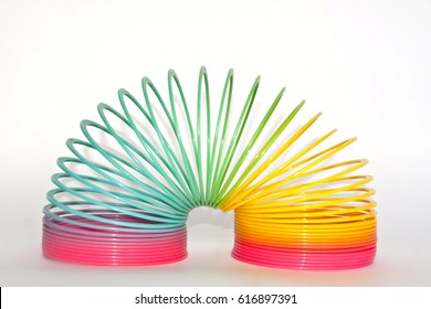 Toy plastic rainbow on a white background, color spiral for play