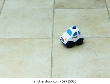 Toy Police Car On A Tiled Floor