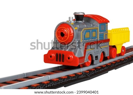toy railroad with battery-powered steam locomotives and railway track, isolated on white background, close-up