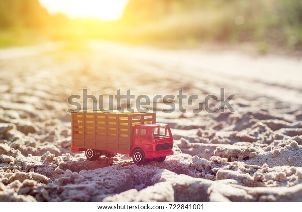Toy retro truck on the road - a symbol of\
cargo transportation