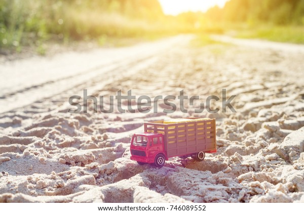 Toy retro truck on the road - a symbol of\
cargo transportation