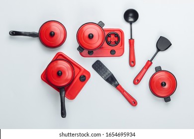 Toy Set Of Children's Kitchen On White Background. Pots, Kitchen Tools, Stove. Top View