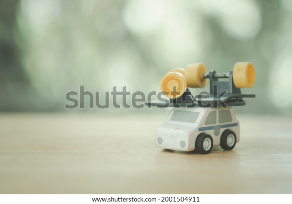 Toy skateboard broken placed on\
ambulance on nature blurred background. Insurance\
concept