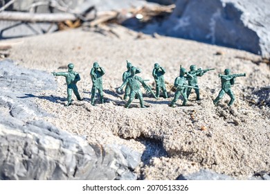 Toy Soldiers On A Sandy Battlefield At The Beach