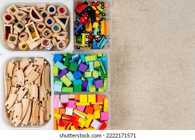 Toy Storage Boxs In The Children's Room. Plastic Containers With Colorful Wooden Toys. Organizing And Storage Ideas In Nursery. Clean Up Toys And Reduce The Clutter. Top View