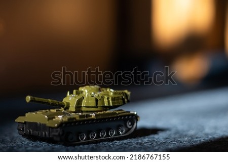 Toy tank with camouflage color. Military vehicles toy. Simple cheap toys for children, warfare, warzone vehicles