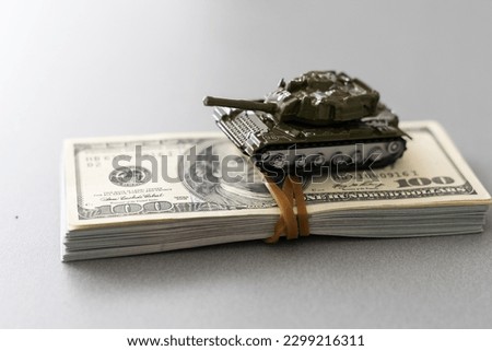 a toy tank, dollars, business