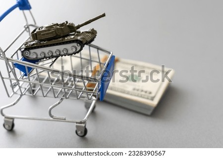 a toy tank, dollars and a cart