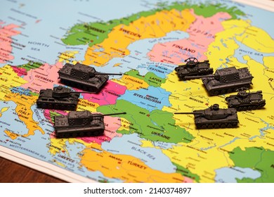 Toy tanks on the map. Concept of confrontation between NATO and Russia.