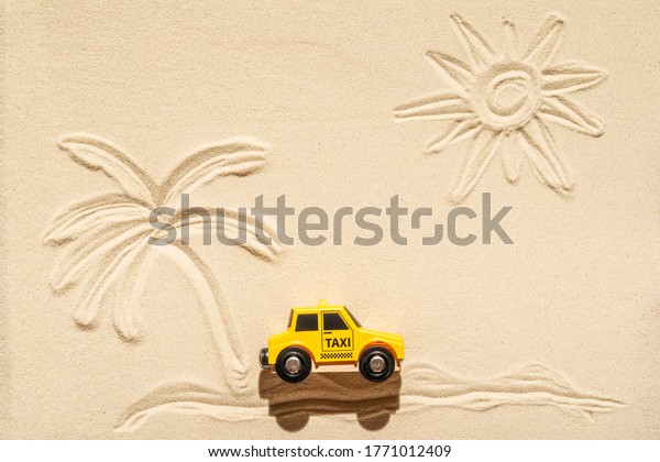 Toy\
taxi car, sun, palm tree on beach sand. Concept. Fast and cheap\
taxi booking service. Travel. Summer time. Creative\
