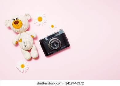 Toy Teddy Bear With Daisies And Vintage Old Camera Isolated On A Pink Background. Baby Background. Copy Space, Top View