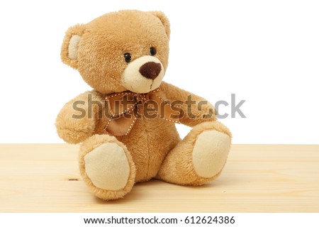 toy teddy on wood background