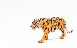 A Toy Tiger, A Miniature Model Of An Animal On A White Background. Symbol Of The Year