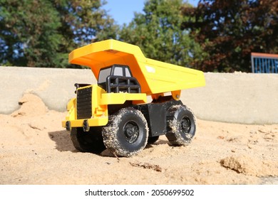 Toy Tonka Truck In A Sandpit.