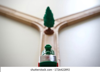 Toy train approaching a fork in the track with a tree blocking its path