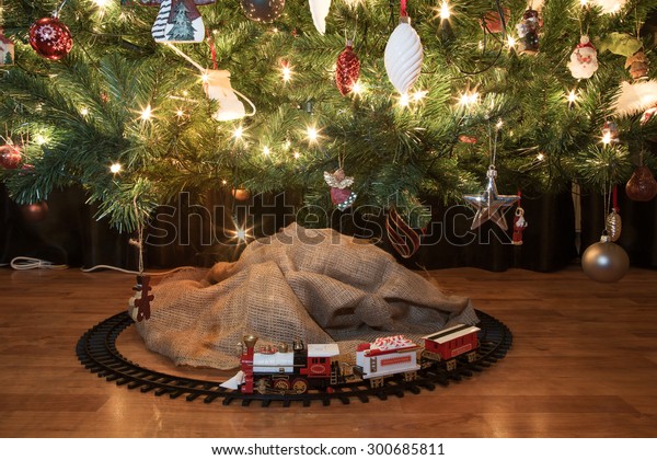 toy train around christmas tree