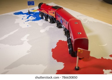 Toy train connecting Europa and China. Symbolizing the New Silk Road or one belt one road Chinese strategic investment in the 21st century. Economic project to connect EU, Central Asia and China